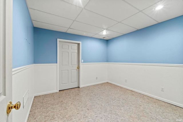 unfurnished room with a drop ceiling