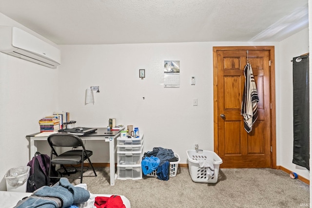 carpeted office featuring a wall unit AC and a textured ceiling