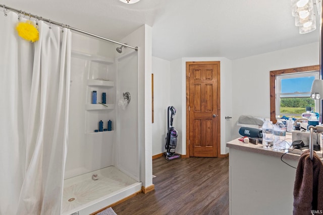 bathroom with walk in shower and hardwood / wood-style floors