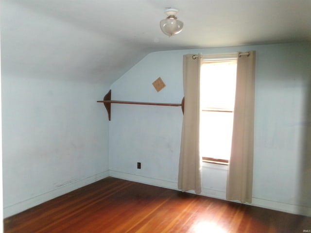 bonus room featuring lofted ceiling and dark hardwood / wood-style flooring