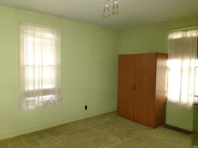 unfurnished bedroom featuring light carpet