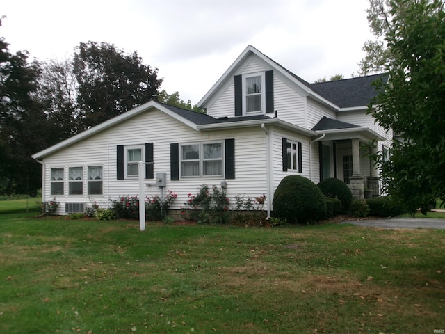 view of front of home featuring central AC and a front yard