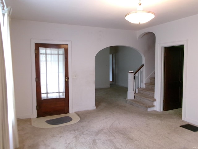 view of carpeted entrance foyer