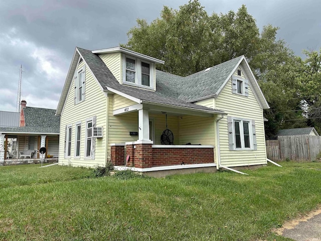 cape cod house with cooling unit and a front lawn