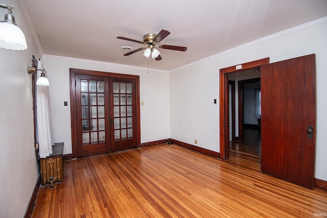 spare room featuring crown molding, radiator, ceiling fan, and light hardwood / wood-style flooring