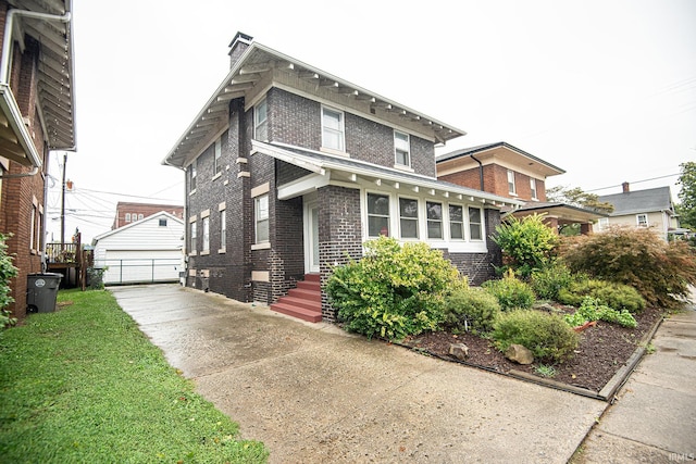 view of front facade featuring an outbuilding and a garage