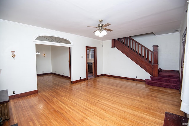 unfurnished living room featuring light hardwood / wood-style floors, ceiling fan, and crown molding