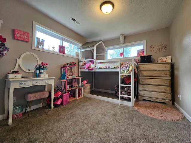carpeted bedroom featuring multiple windows and a textured ceiling