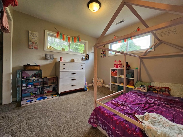 carpeted bedroom featuring lofted ceiling and multiple windows