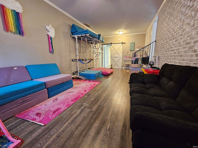 interior space featuring wood-type flooring, crown molding, and a barn door