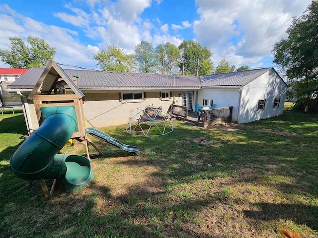 exterior space with a wooden deck and a lawn