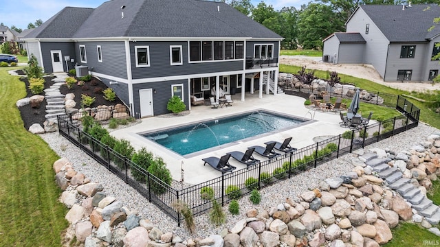 back of property featuring a lawn, central AC unit, and a patio area