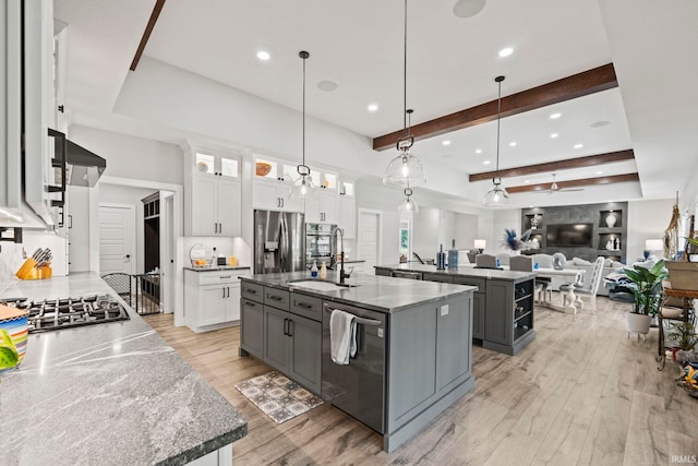 kitchen with white cabinets, an island with sink, gray cabinetry, decorative light fixtures, and stainless steel appliances