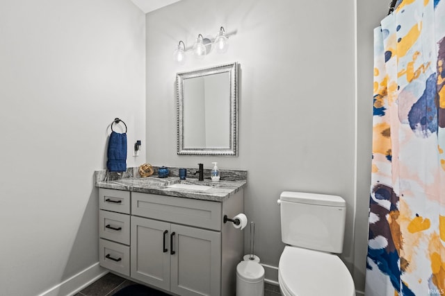 bathroom with vanity, toilet, and tile patterned floors