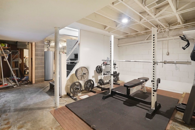 exercise area with concrete floors and water heater