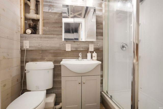 bathroom with walk in shower, vanity, and toilet