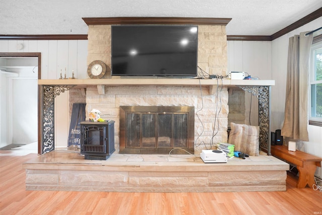 room details with a textured ceiling, crown molding, wood walls, and hardwood / wood-style flooring