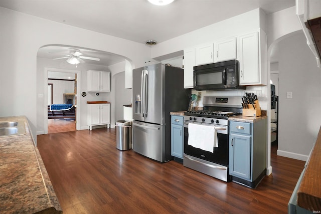 kitchen featuring blue cabinets, white cabinetry, dark wood-type flooring, and stainless steel appliances