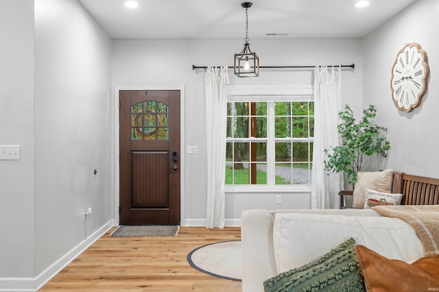 foyer entrance featuring a notable chandelier and hardwood / wood-style floors