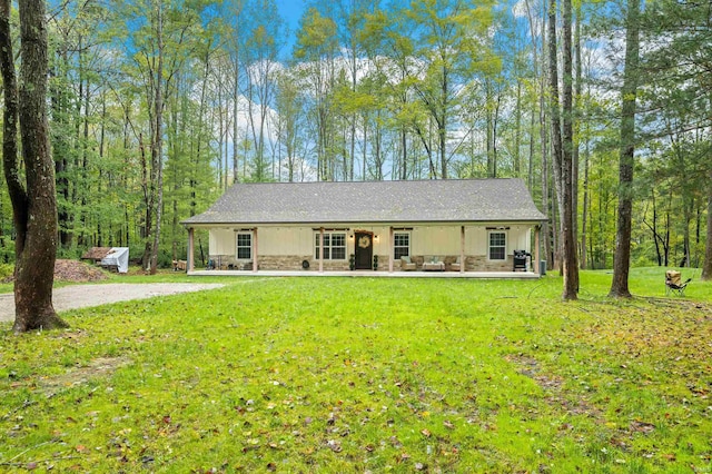 single story home with a front lawn and a porch