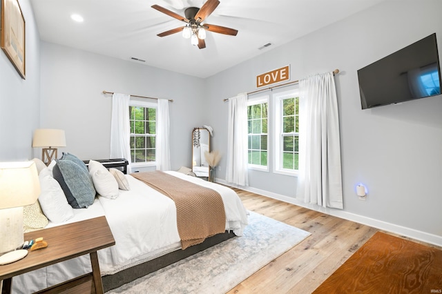 bedroom with ceiling fan and hardwood / wood-style flooring