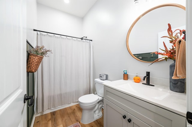 bathroom with hardwood / wood-style floors, vanity, and toilet