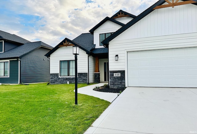 view of front of property featuring a garage and a front lawn