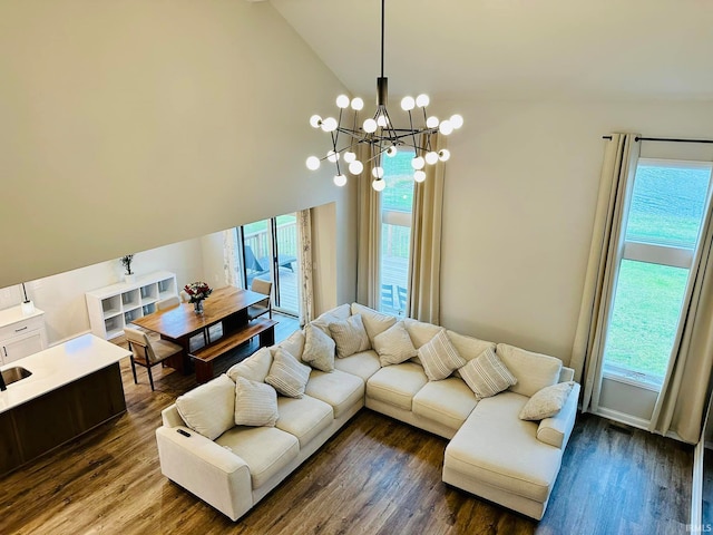 living room featuring wood-type flooring, an inviting chandelier, high vaulted ceiling, and plenty of natural light