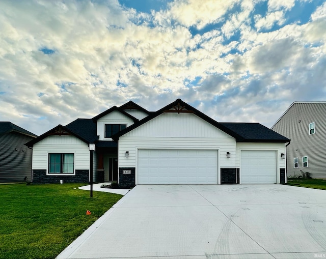 view of front of property with a garage and a front lawn