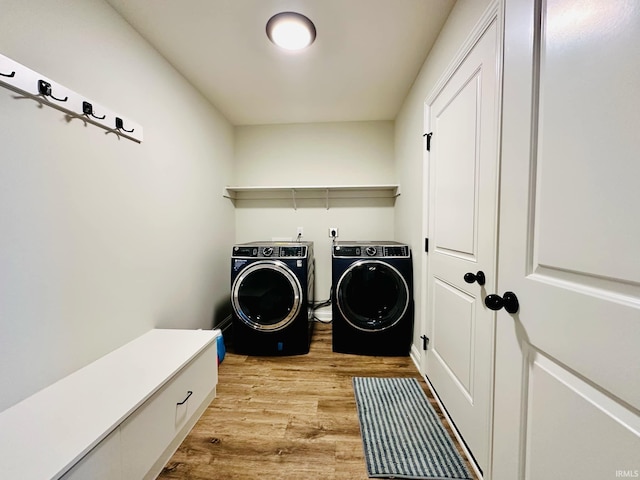 washroom featuring light hardwood / wood-style floors and washer and dryer