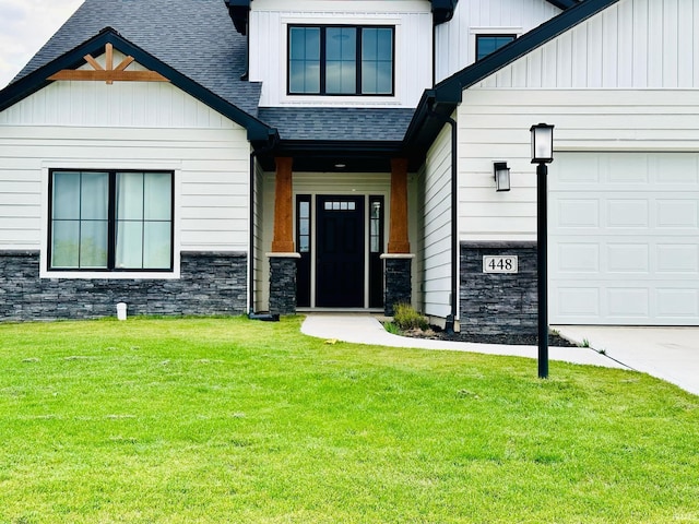 property entrance with a lawn and a garage