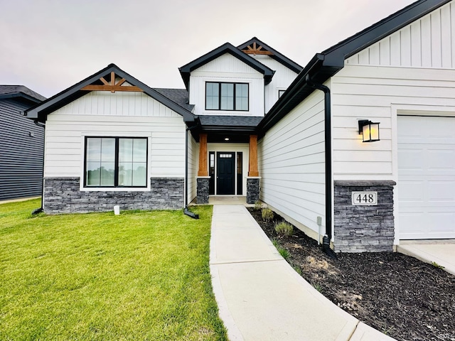 view of exterior entry with a lawn and a garage