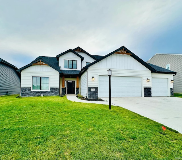 view of front of property featuring a garage and a front lawn