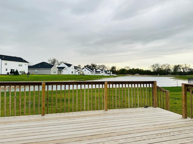 deck with a water view and a yard