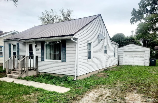 view of front of house with an outdoor structure, a garage, and a front yard