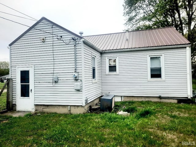 rear view of house with a yard