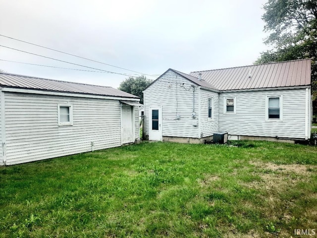 back of property featuring a lawn