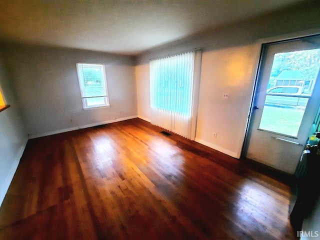 unfurnished room featuring dark wood-type flooring