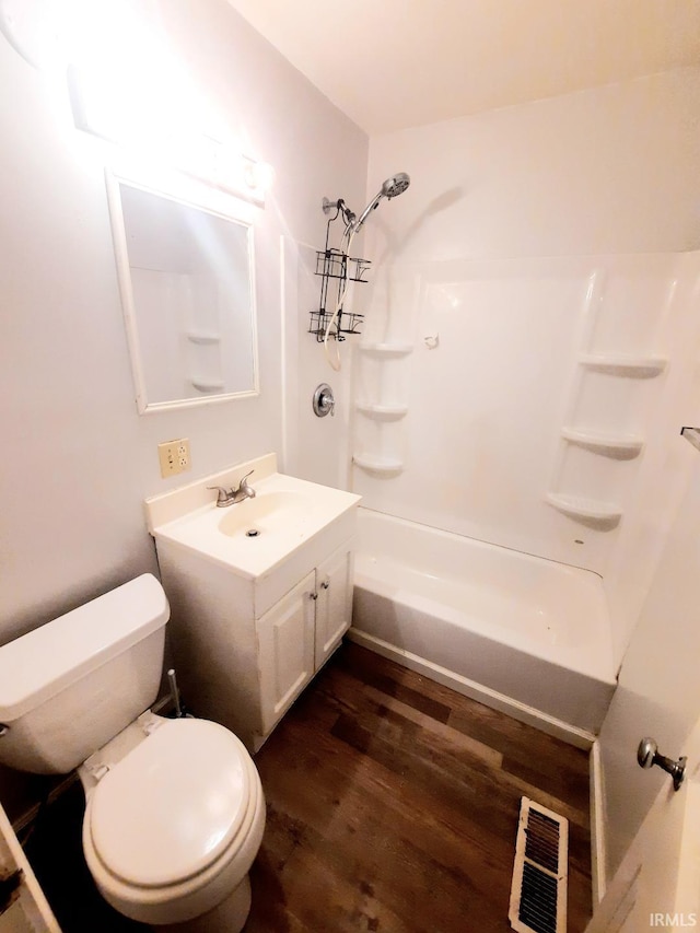 full bathroom with vanity, hardwood / wood-style flooring, toilet, and washtub / shower combination