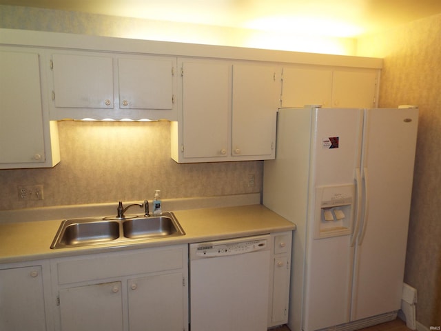 kitchen featuring backsplash, sink, white appliances, and white cabinetry