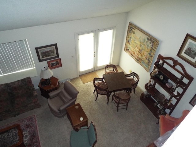 living room featuring carpet floors, vaulted ceiling, and french doors