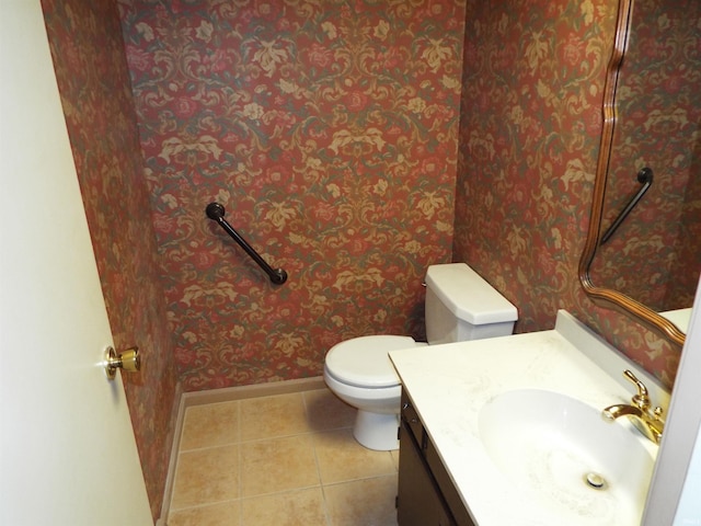 bathroom featuring tile patterned flooring, vanity, and toilet