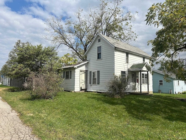 back of house with a lawn