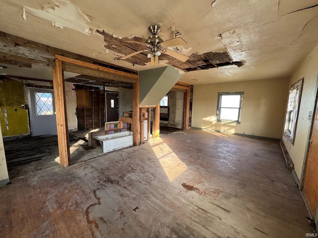 interior space with ceiling fan