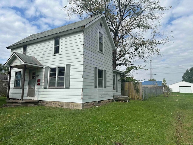 rear view of house with a yard