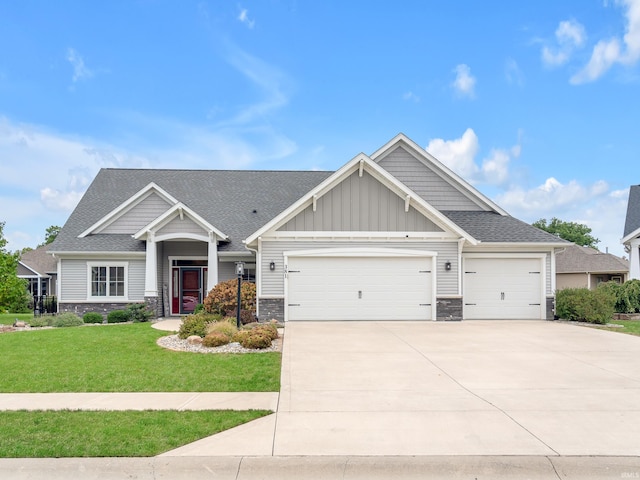 craftsman house with a front yard and a garage