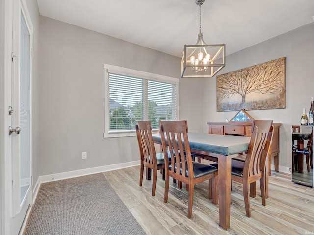 381 Elderwood Ct, Fort Wayne, IN 46845 - dining area with light wood-type flooring, an inviting chandelier, and baseboards