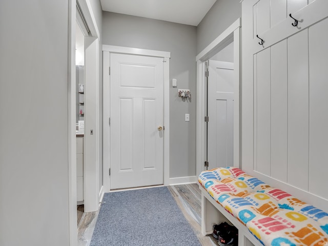 mudroom with wood-type flooring