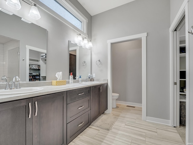 bathroom featuring hardwood / wood-style flooring, vanity, and toilet