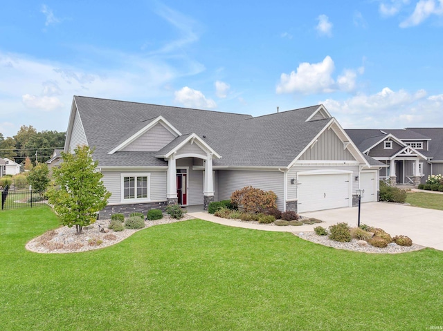 381 Elderwood Ct, Fort Wayne, IN 46845 - craftsman inspired home with driveway, board and batten siding, an attached garage, a front lawn, and fence